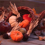 A wicker basket filled with apples and pumpkins.