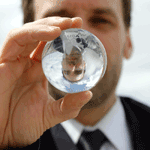 A man in a suit holding a glass ball.