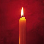 A lit candle on a red background.