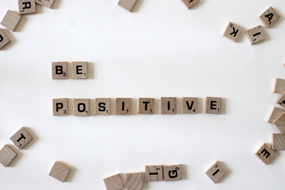 The word be positive spelled out in wooden blocks.